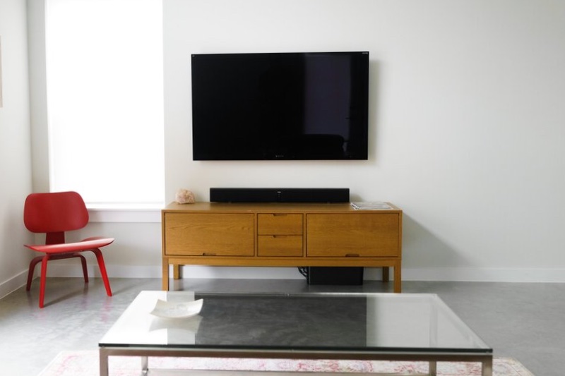 If you prefer placing your TV on the walls and watching from a low chair, the position below the TV will be better for soundbars.